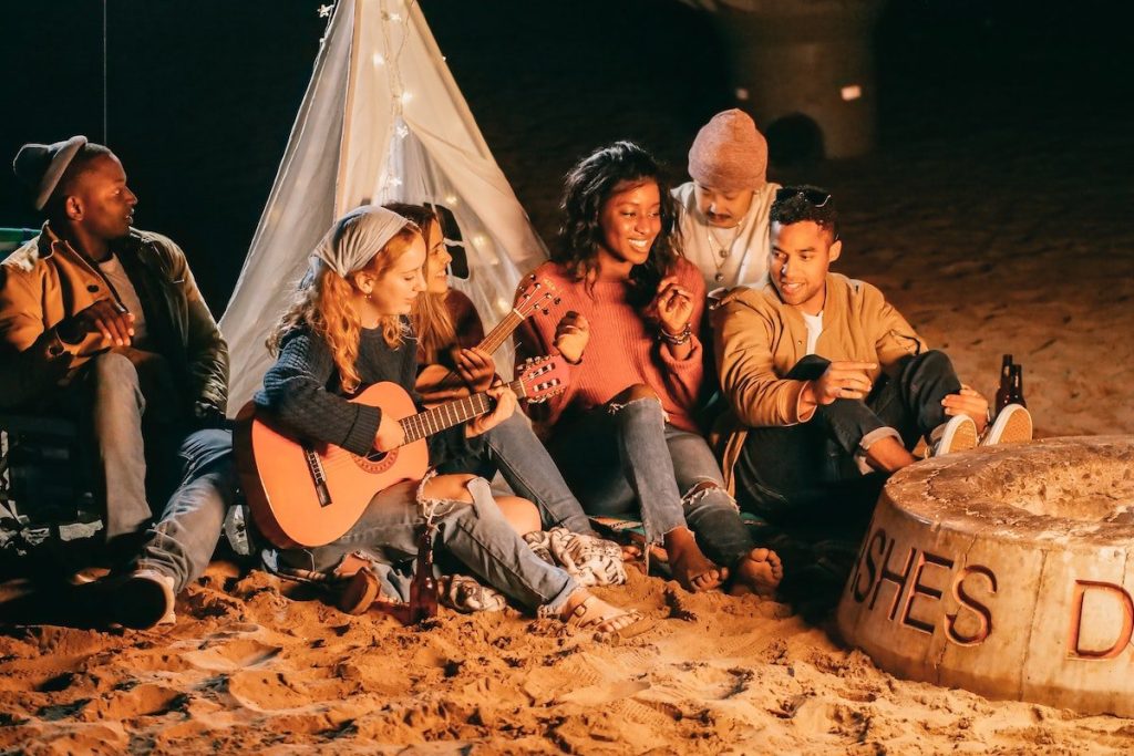 A Christ-centered group sitting around a campfire in an online retreat sanctuary.